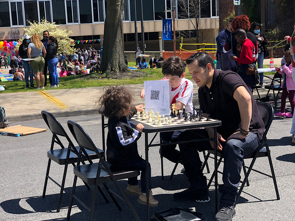 An intense game of chess ensues on Grand Street.